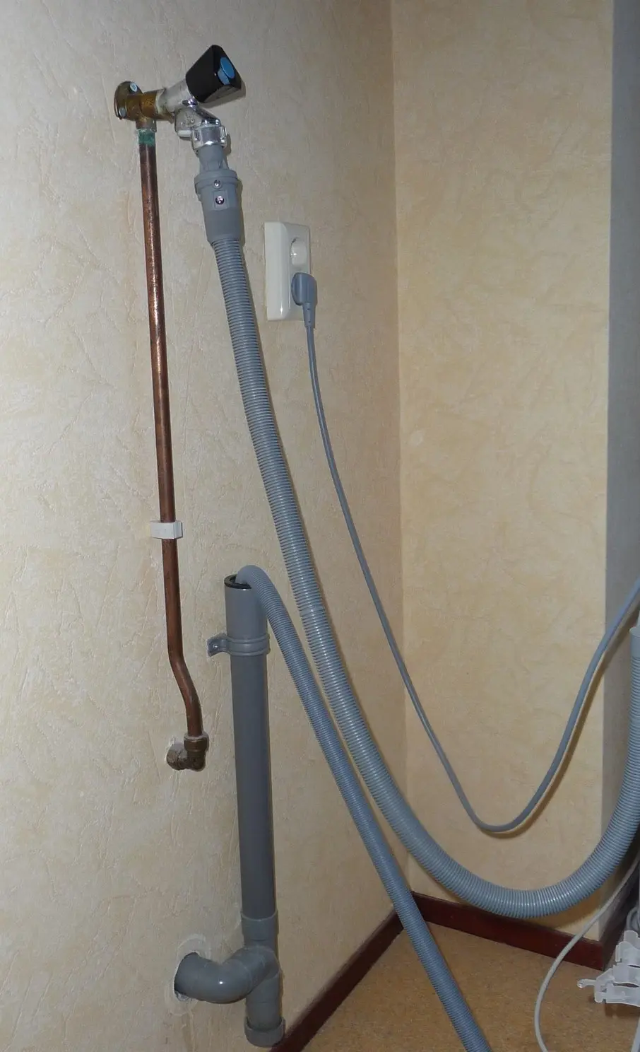 Metal water pipes along a building wall