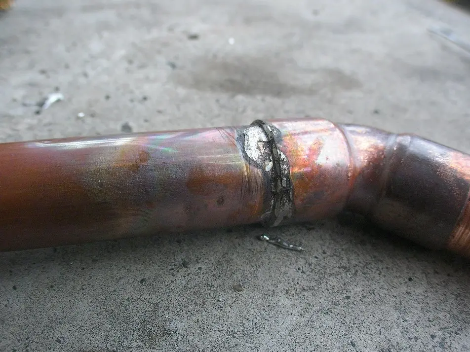 Plumber assembling and fitting water pipes